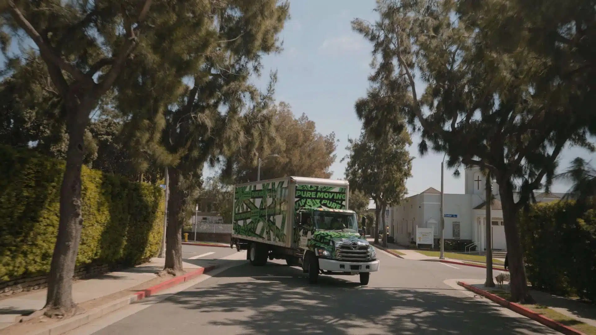 A moving truck painted with green camo patterns and 